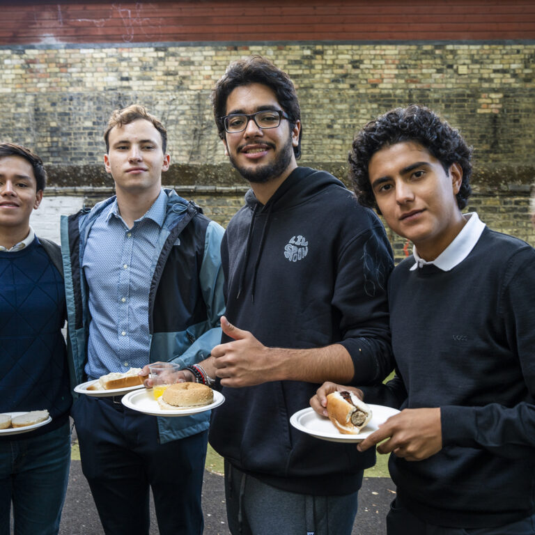 students holding plates of barbecue food